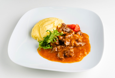 meat with mashed potato on the white plateの写真素材