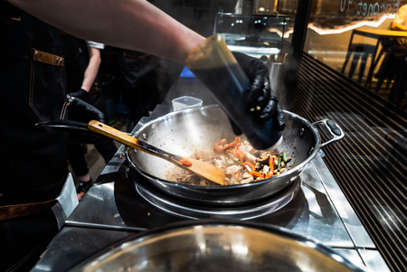 chef making wok boxの写真素材