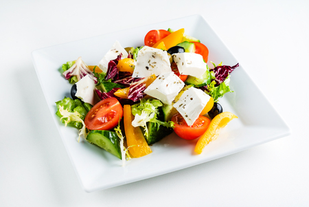 greek salad with feta on the white plateの写真素材