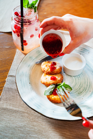 Woman having breakfast in the cafeの写真素材