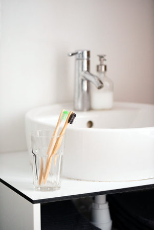 eco natural bamboo toothbrushes in glass. sustainable lifestyle concept. zero waste home. bathroom...