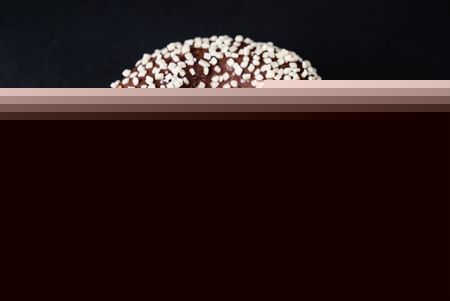 chocolate donut on the black backgroundの写真素材