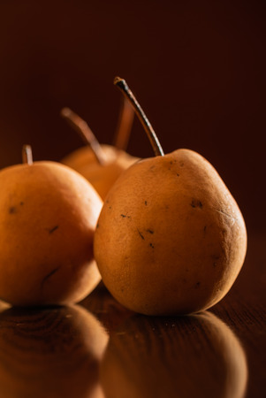 fresh fruits-yellow pears on the tableの写真素材
