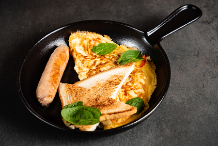 omelet with toasts and sausageの写真素材