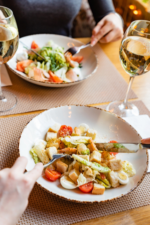 Dinner in the restaurant, couple eating in the restaurantの写真素材