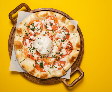 Vegetarian pizza with tomato and mozzarellaの写真素材