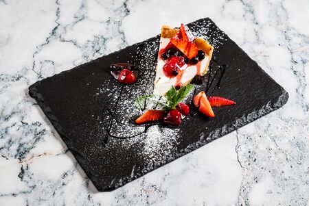 Cheesecake with fresh strawberries and mintの写真素材