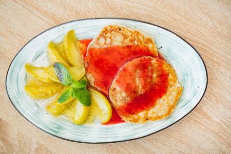 woman eating pancakes with apples