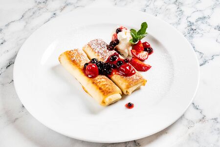 Pancakes with strawberries and mintの写真素材