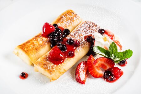 Pancakes with strawberries and mintの写真素材
