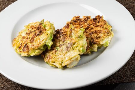 vegetable pancakes on the white plateの写真素材