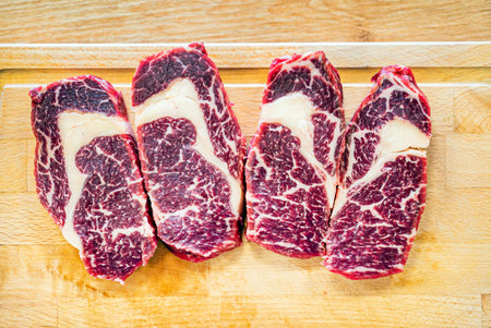 Large Raw Meat Steaks On Tableの写真素材