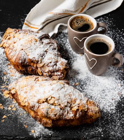 Croissants with almonds on the black backgroundの写真素材