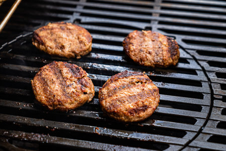 chef making grilled cutlets for burgersの写真素材