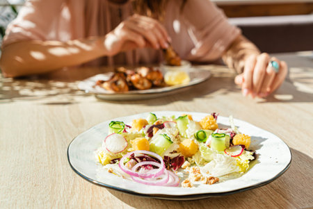 woman eating tasty salad in the cafeの写真素材