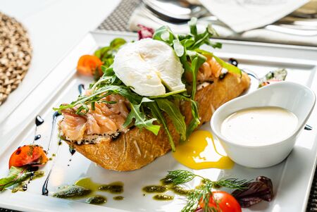 sandwich with salted salmon and poached eggの写真素材