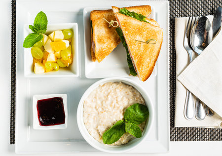 breakfast in the cafe with oatmeal and sandwich