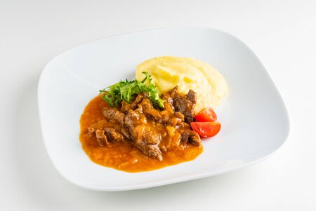 meat with mashed potato on the white plateの写真素材