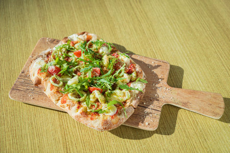 fresh pizza with calamari and arugula