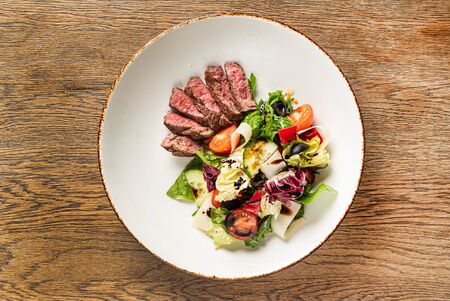 Salad with beef on the woodenの写真素材