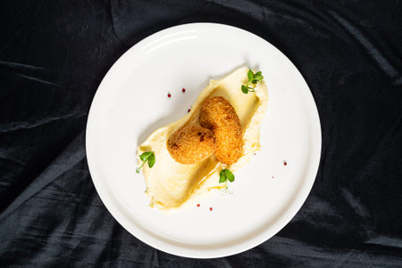 Chicken cutlet with mashed potato on marble plate