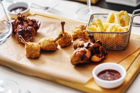 Chicken with french fries on wooden boardの写真素材