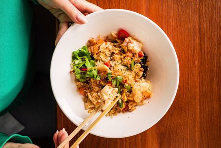 woman eating rice with vegetablesの写真素材