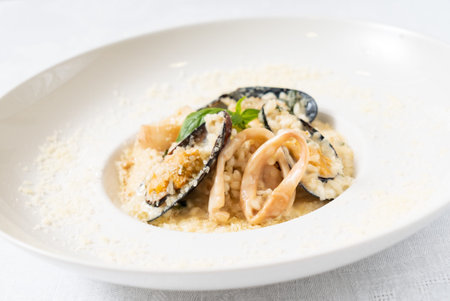 Risotto with mussels on white plateの写真素材
