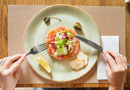 fish tartar with salad and lemonの写真素材