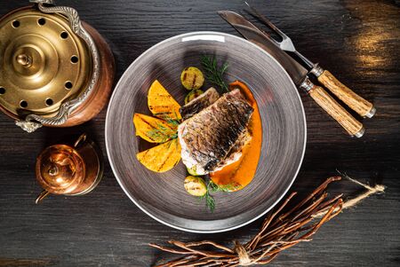 roasted carp fish with grilled vegetablesの写真素材