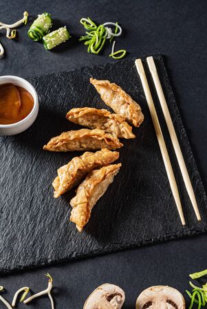 Fried pot stickers on a black backgroundの写真素材