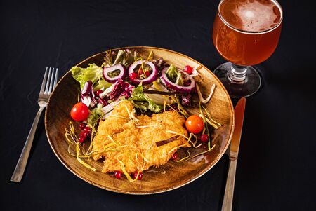 schnitzel with salad and beerの写真素材