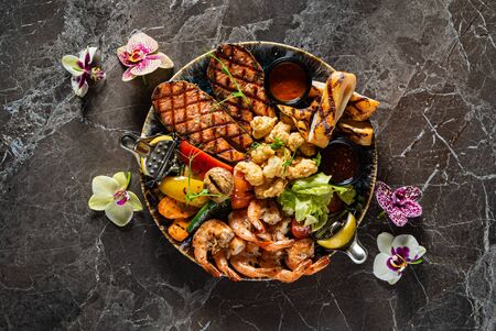 grilled seafoodwith vegetables and sauceの写真素材