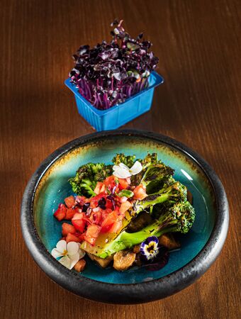 roasted vegetables with edible flowers and microgreensの写真素材