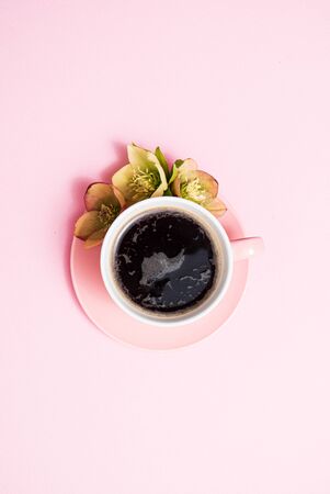cup of coffee and flowers on the pink backgroundの写真素材