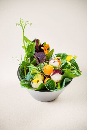 fresh srping salad with edible flowersの写真素材