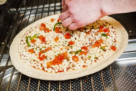 chef making pizza on kitchenの写真素材