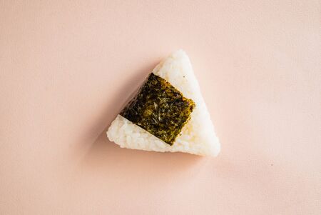 Triangular onigiri on the color backgroundの写真素材