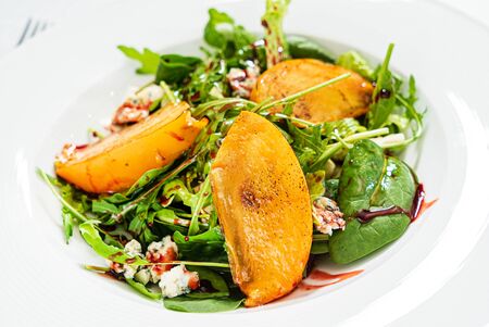 winter salad with persimmon adn nutsの写真素材