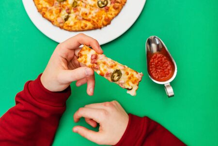 man eating pizza in cafeの写真素材