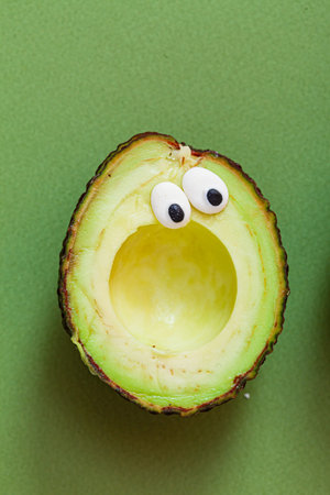 funny avocado on the green background