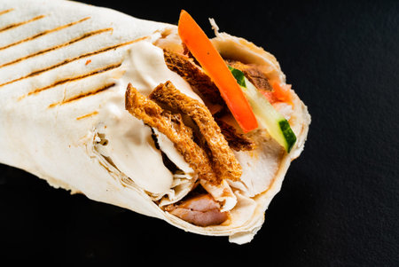 fajita wrap sandwich on the black background
