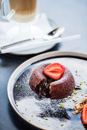 Chocolate fondant (cupcake) with strawberries and ice creamの写真素材