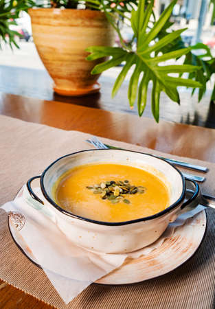 pumpkin cream soup in the bowlの写真素材