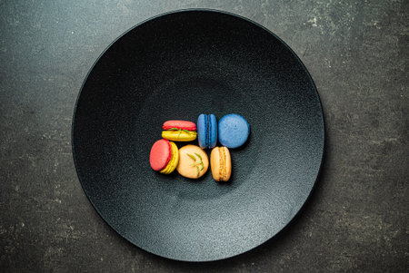 colorful macaroons on the black backgroundの写真素材