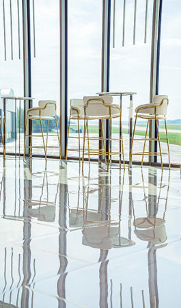 modern white chairs near windowの写真素材