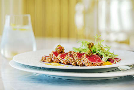 sliced tuna steak with sesame and vegetablesの写真素材