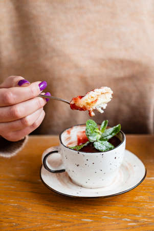 woman eating dessert in the cupの写真素材