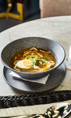 asian soup with noodles and eggの写真素材