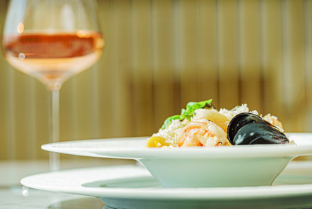 seafood pasta with sauce and wineの写真素材